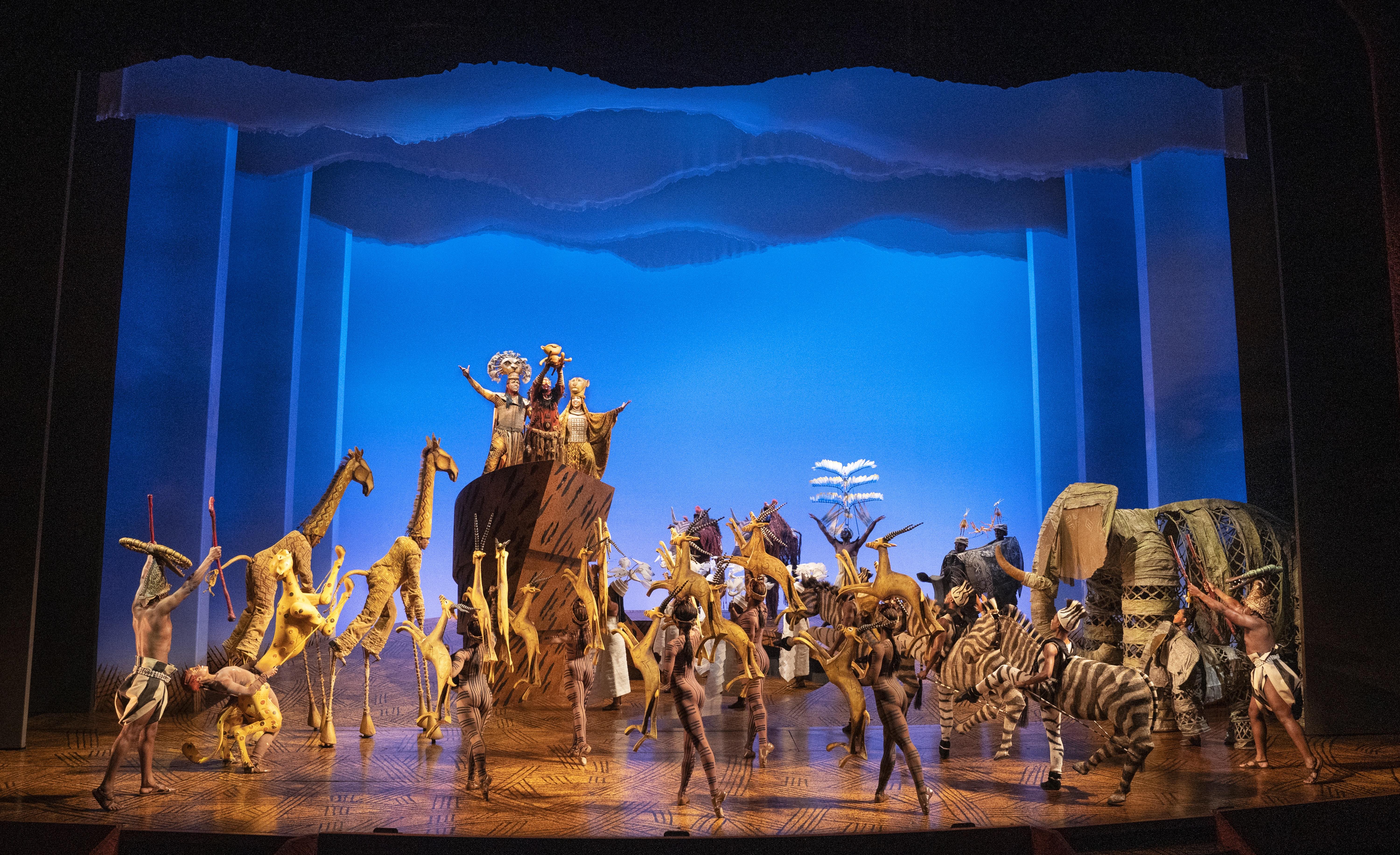 People dressed in different animal costumes on the set of The Lion King
