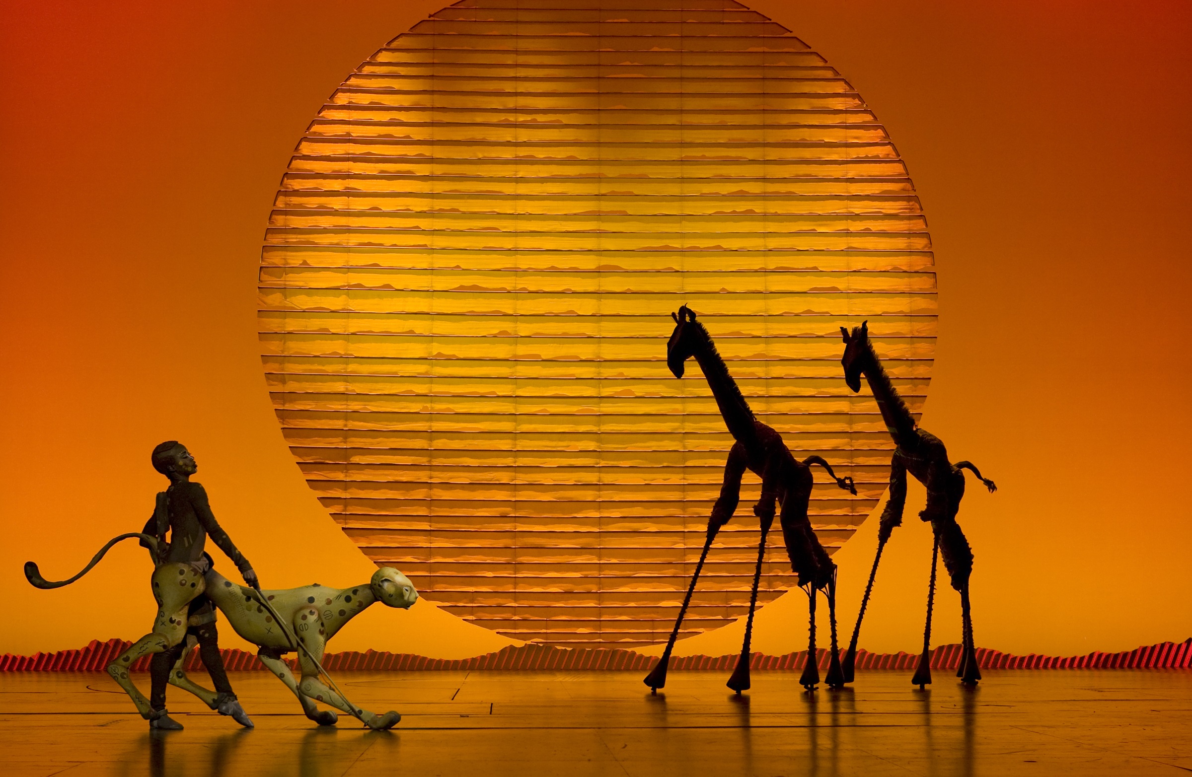 Cheetah and Giraffes on stage for The Lion King